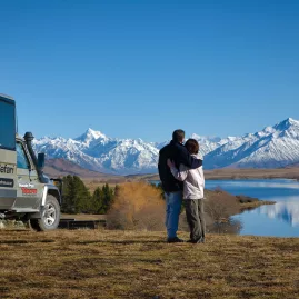 Couple enjoying the snowy Southern Alps on a Lord of the Rings tour near Mount Cook.