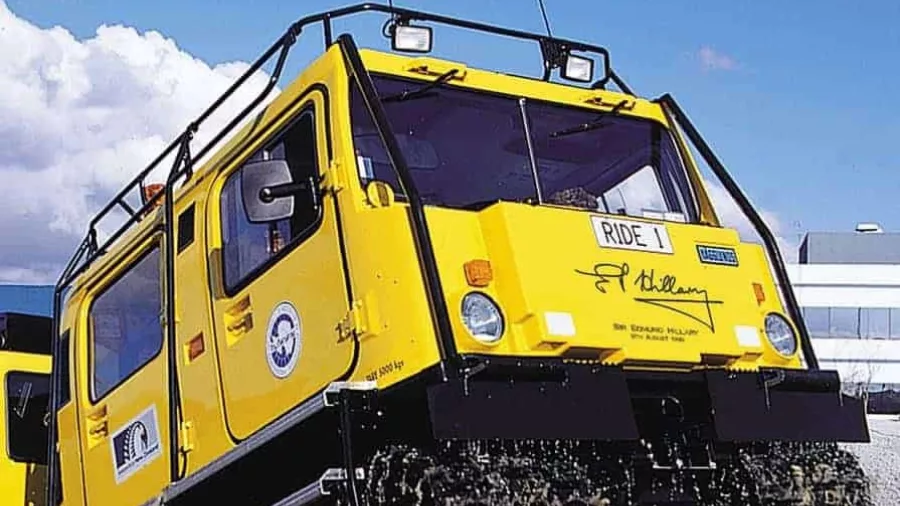 Yellow Hagglund vehicle driving through water during a ride at the International Antarctic Centre