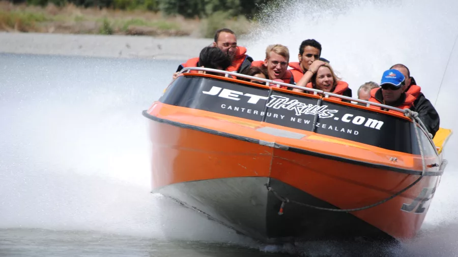 Head-on view of a jet boat splashing through the Waimakariri River at high speed