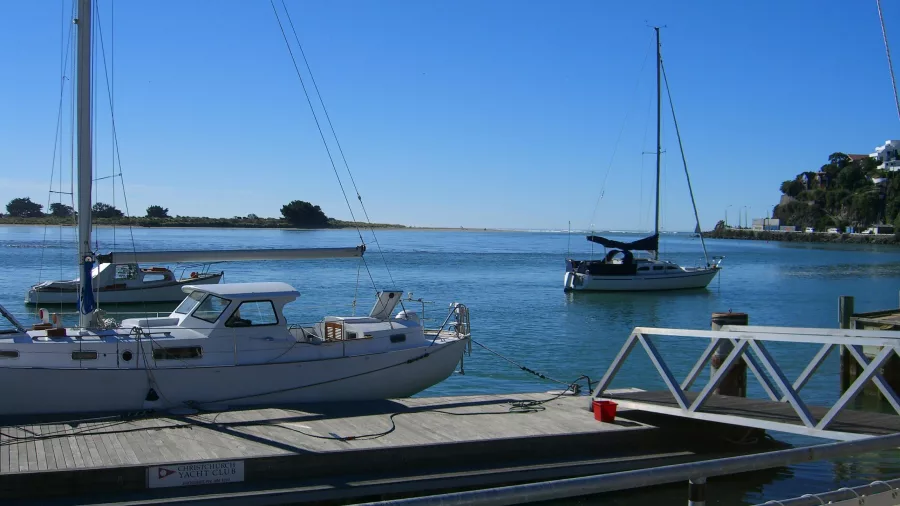 Sailboats moored in the calm waters of the estuary at Redcliffs, Christchurch.