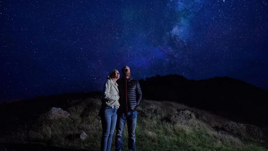 Couple stargazing at Hanmer Springs under the Milky Way