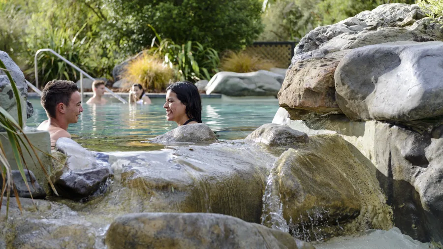 Couple relaxing in rock pools at Hanmer Springs Thermal Pools and Spa