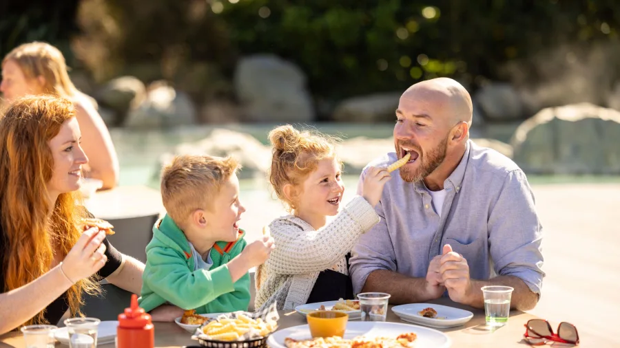 Family enjoying freshly made pizza at Tea Kiosk Café & Grill in Hanmer Springs