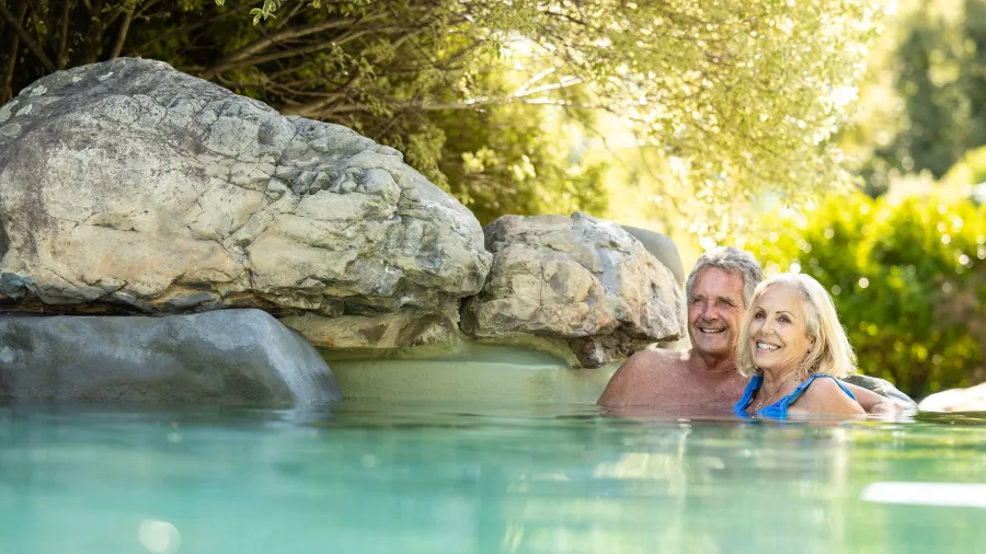 Couple relaxing in rock pools at Hanmer Springs Thermal Pools and Spa