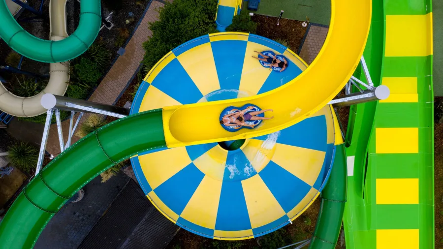 Aerial view of Conical Thrill water slide passing over SuperBowl at Hanmer Springs Thermal Pools and Spa