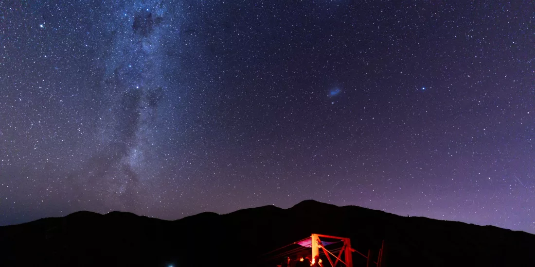 Couple stargazing together beneath the Milky Way in Kaikōura.