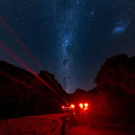 Milky Way visible above zipliners preparing for a night ride in Kaikōura Dark Sky Sanctuary.
