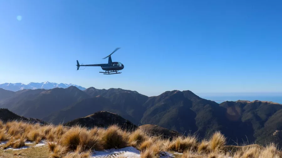 Helicopter flying over the rugged Seaward Kaikōura Range on a Grand Alpine Tour