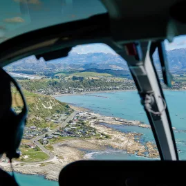 Aerial view of Kaikōura coast from helicopter cockpit during whale watching flight