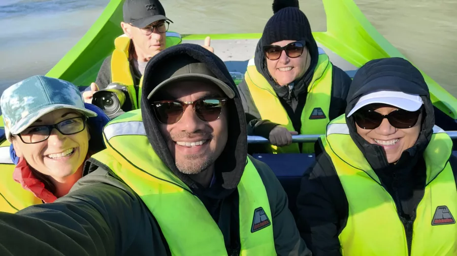 Group selfie on jet boat during Kaikōura Heli-Jet tour, all wearing life jackets