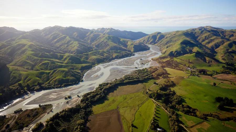 Scenic aerial view of Hurunui River winding through rolling Canterbury hills