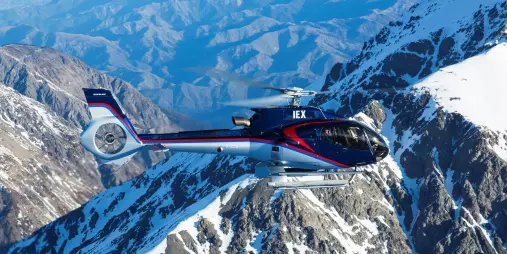 Kaikōura Helicopters navigating through snowy Seaward Ranges with deep valleys below