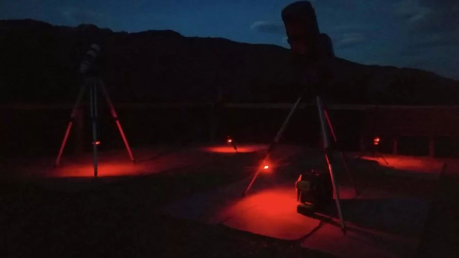 Telescopes under red light on stargazing pad at Manuka Skies, Hanmer Springs