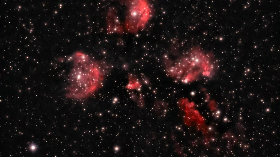 Red emission nebula captured through telescope during deep sky tour with Manuka Skies