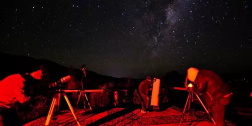 People stargazing at Mt Lyford with telescopes under the Milky Way