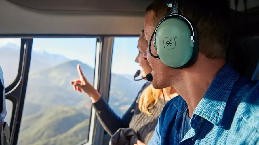 Couple enjoying scenic views from helicopter cabin during Mt Fyffe flight