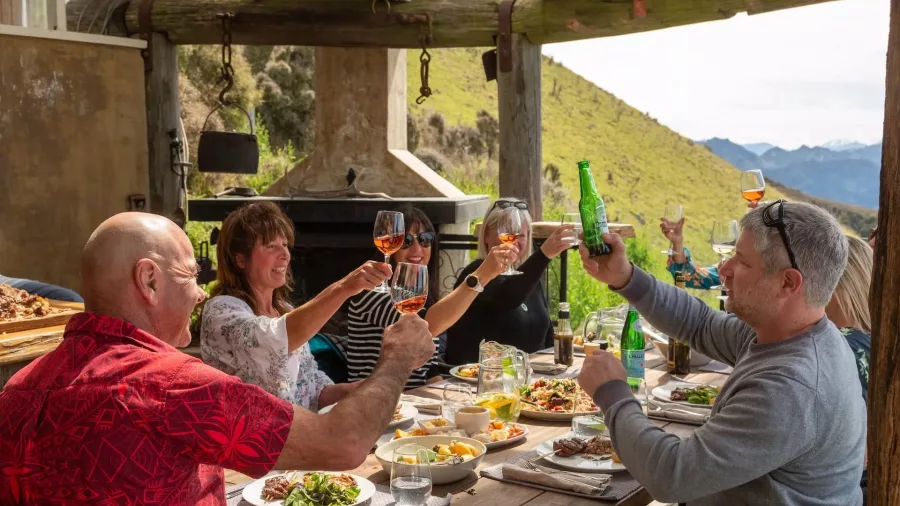 Group enjoying a gourmet lunch and drinks at Matai Peak luxury experience