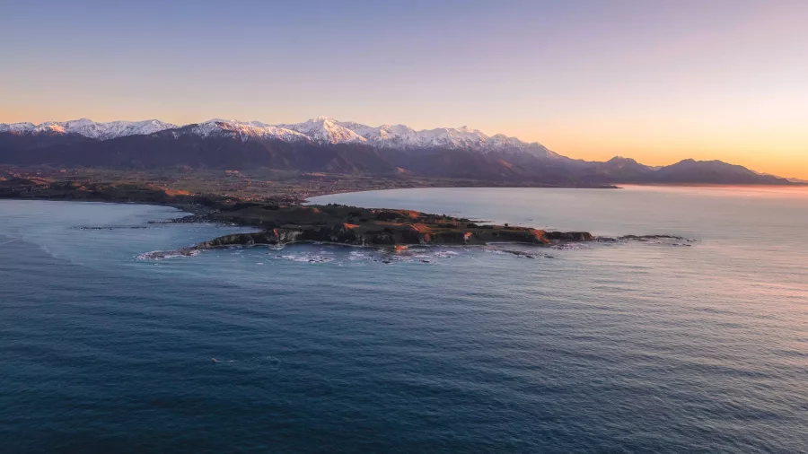 Aerial view of Kaikōura Peninsula and coastline at sunset from scenic helicopter flight