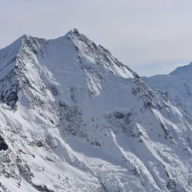 Aerial shot of Aoraki/Mt Cook’s snow-covered summit and rugged alpine peaks