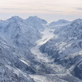 Aerial view of Tasman Valley and multiple glaciers surrounded by towering peaks