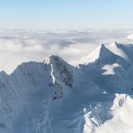 Southern Alps peaks rising above a thick cloud inversion on a sunny day
