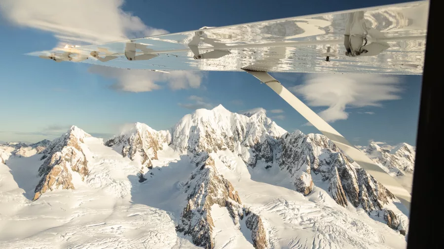 Aerial view of Mount Tasman and the Fox Glacier Névé during a Grand Traverse scenic flight over the Southern Alps.