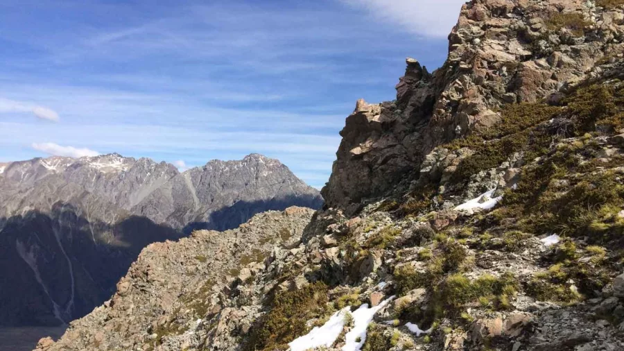 Rocky outcrop along Mount Wakefield with distant views of the Southern Alps.