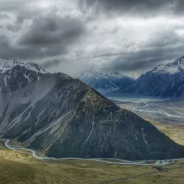 Dramatic clouds roll over the Hooker Valley with braided rivers and alpine peaks near Mount Sebastopol.