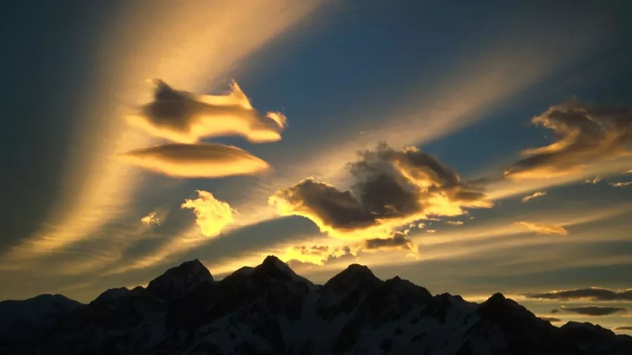 Golden sunset cloud formations over the jagged peaks of the Malte Brun Range near Aoraki Mt Cook.