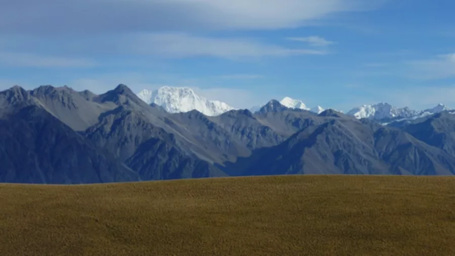 Distant view of Aoraki Mount Cook rising above the Southern Alps, seen from the Tekapo high country.