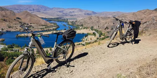 E-bikes parked on the Alps 2 Ocean Trail overlooking Aviemore Dam and Waitaki River