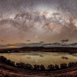 Panoramic view of the Milky Way reflected in a lake near Tekapo under crystal-clear night skies
