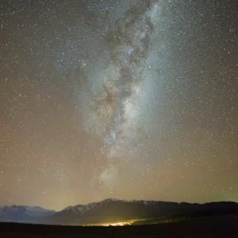 Milky Way stretching across the sky above Mt Edward near Lake Tekapo at night