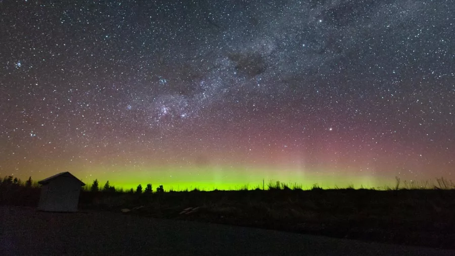 Aurora Australis glowing green and pink under the stars at Lake Tekapo