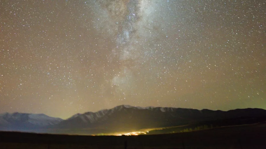 Milky Way stretching across the sky above Mt Edward near Lake Tekapo at night