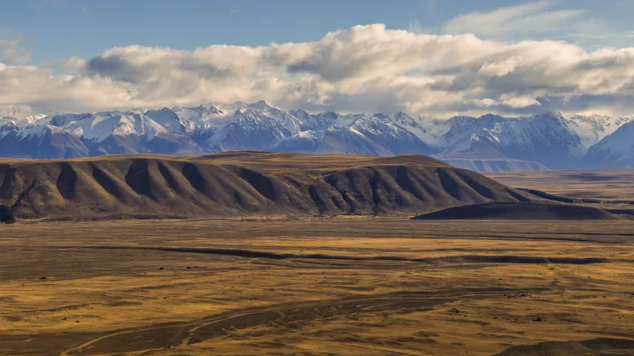 Expansive view of Tekapo’s high country plains and snow-capped Southern Alps in the distance