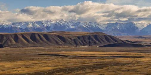 Expansive view of Tekapo’s high country plains and snow-capped Southern Alps in the distance