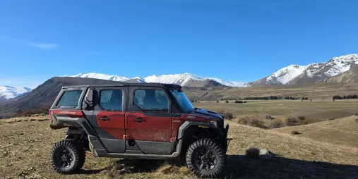 Polaris all-terrain vehicle exploring high-country landscape at Mount Hay Station