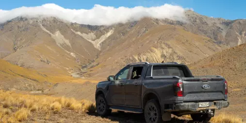 4WD vehicle parked on high country terrain with mountain ranges in the background during a Tekapo hunting tour