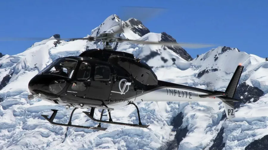 Helicopter flying over snowy peaks during the Grand Circle Scenic Flight at Mount Cook
