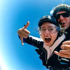 Excited tandem skydivers during parachute ride over Mount Cook region