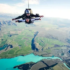 Tandem skydivers freefalling over Lake Pukaki with Mount Cook views
