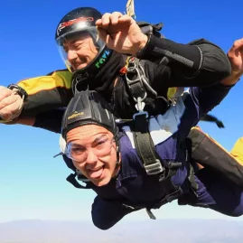 Excited tandem skydiver during freefall over the Mount Cook region