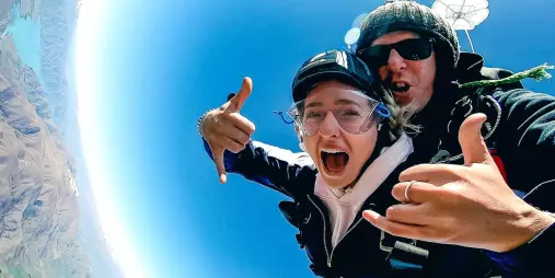 Excited tandem skydivers during parachute ride over Mount Cook region