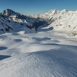 Snowy alpine valley and rugged peaks viewed during a scenic helicopter flight near Aoraki/Mount Cook
