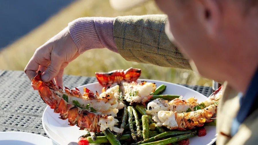 Crayfish tails served with grilled asparagus and cherry tomatoes during scenic heli experience
