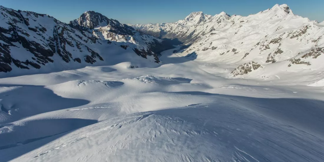 Aerial view of the snow-covered Tasman Glacier stretching through the Southern Alps