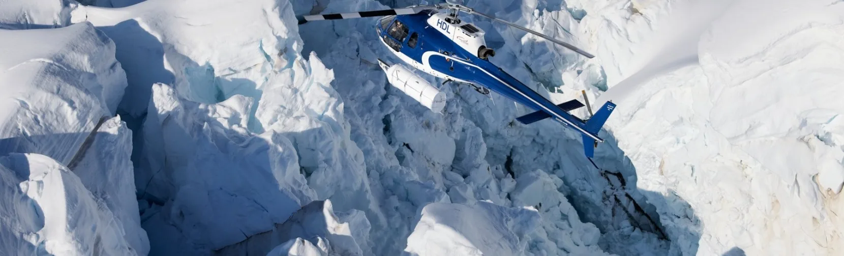 Helicopter flying over the dramatic Hochstetter Icefall near Mount Cook