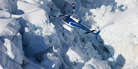 Helicopter flying over the dramatic Hochstetter Icefall near Mount Cook