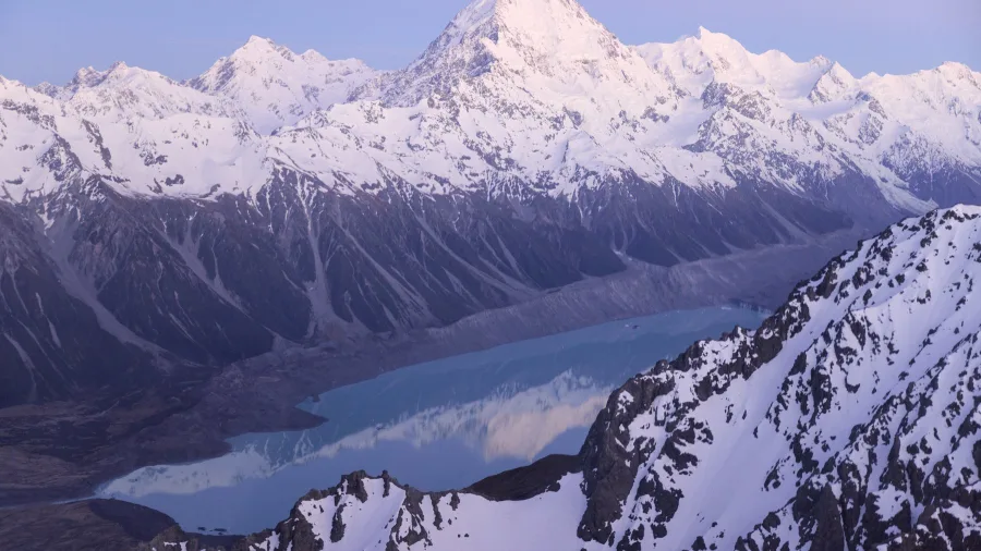 Aoraki Mount Cook reflecting in Lake Pukaki during a scenic helicopter flight